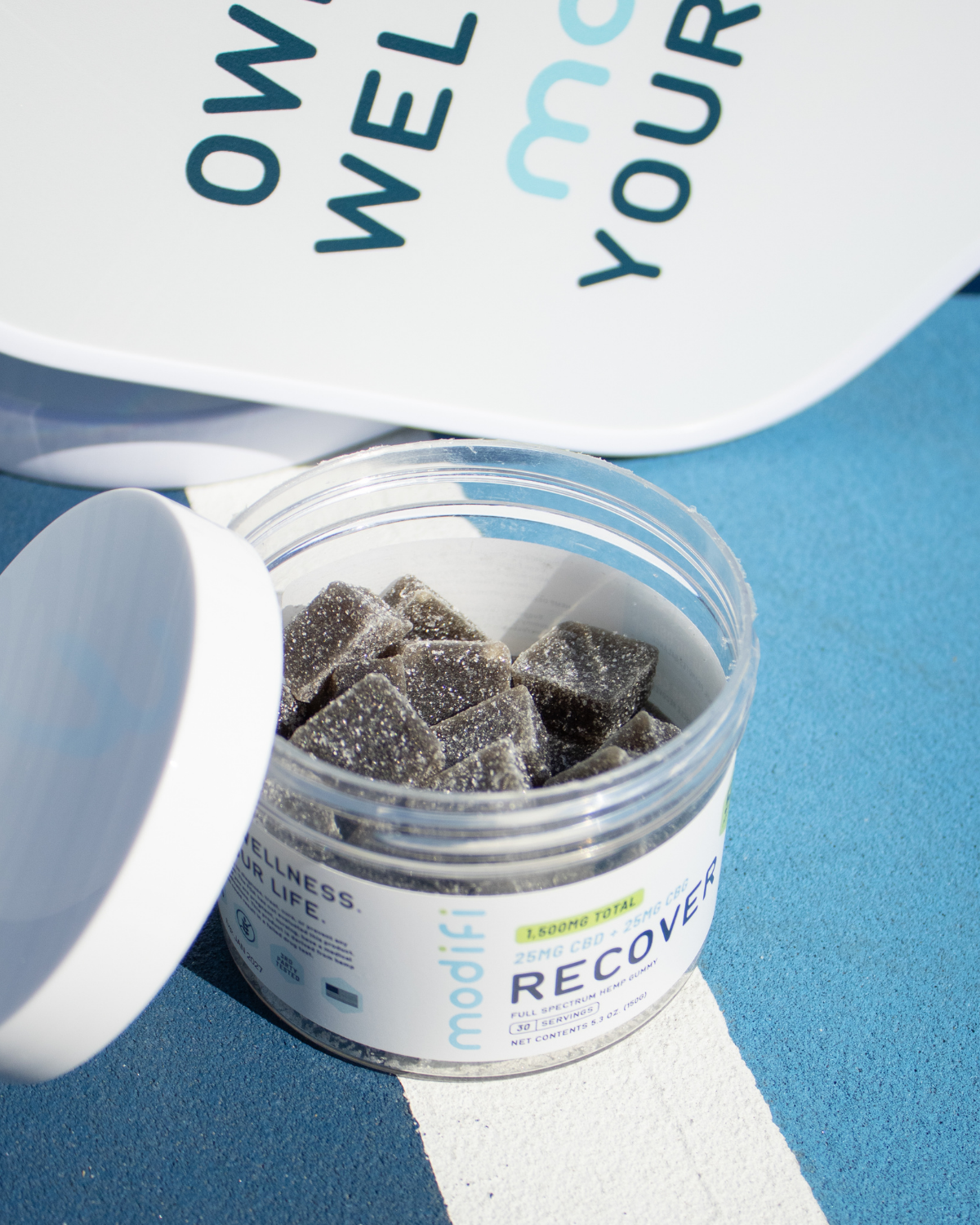 Jar of gummies with a blue background and Modifi branding.
